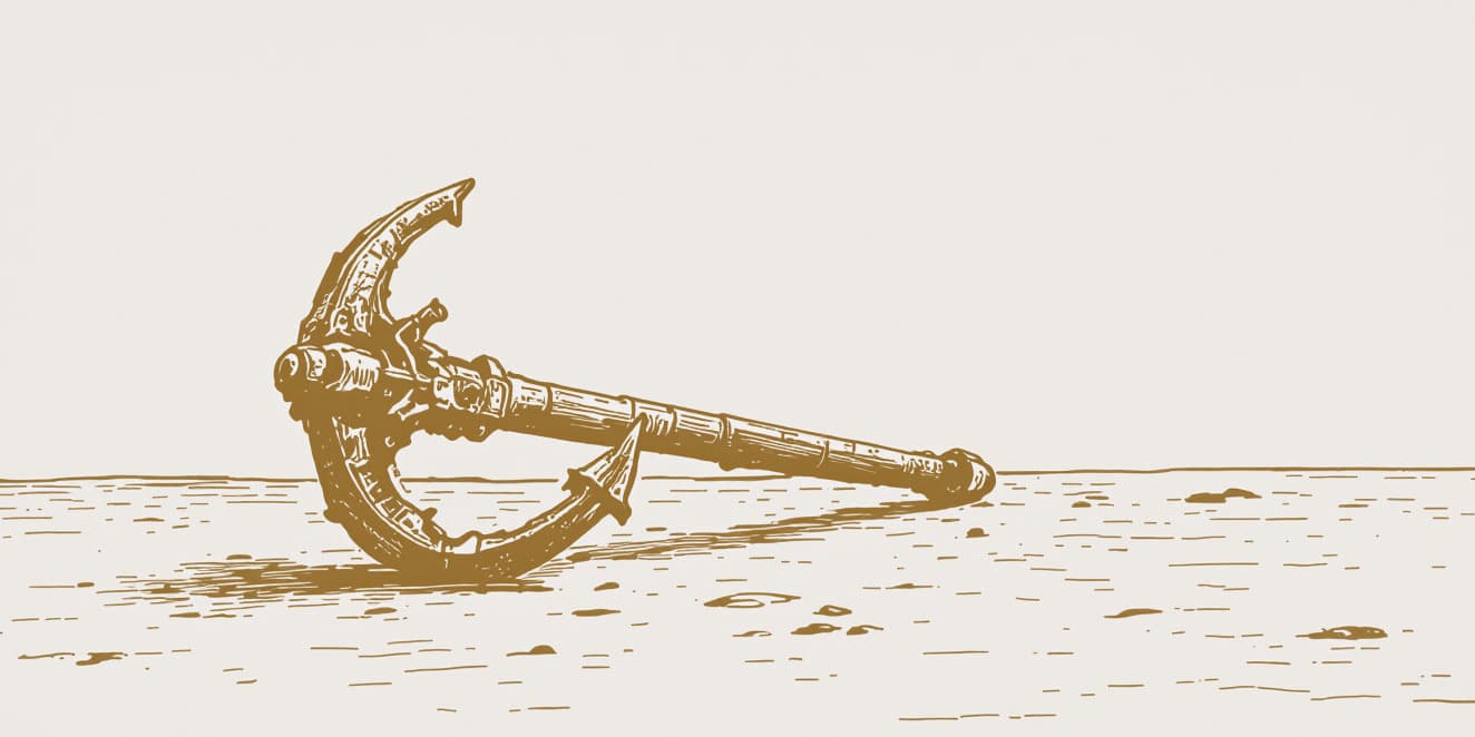 A drawing of an old anchor lying on its side in sand, in gold line on pale paper.