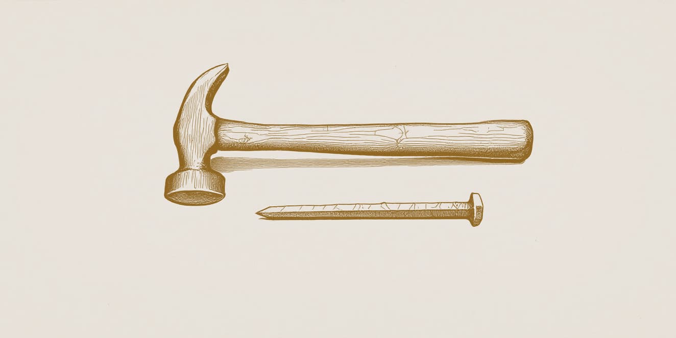 A drawing of a claw hammer lying on its side with a long square-cut nail below it, in gold line on pale paper.